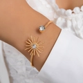 Elegant gold open cuff bracelet featuring a starburst motif and sparkling clear zircon stone - Star Flare Sun Shape Style (25081-gold)