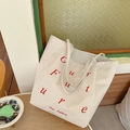 Borsa tote in velluto a coste beige con ricamo Future rosso in un interno accogliente - Bianco Sporco