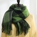 Green and black plaid scarf with fringe tassels on a yellow sweater mannequin - Beibei Plaid Green