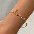 Minimalist gold Love script bangle featuring elegant wire lettering for a chic look - Love Letter Art Line Style (4248-2)