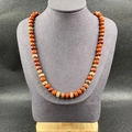 Bohemian natural stone necklace featuring reddish-brown and tan abacus beads on neck display - Rainbow Stone