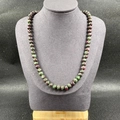 Natural ruby in zoisite beaded necklace on a grey jewelry display mannequin - Ruby Zoisite