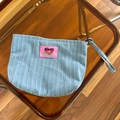 Blue and white striped denim cosmetic bag featuring a pink heart patch with wrist strap - Light Blue Vertical Stripe Denim Makeup Bag