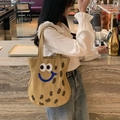 Khaki canvas tote bag with cute cartoon embroidery shown in a cafe setting - Khaki Peanut Large Shoulder