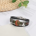 Multilayer leather bracelet with unakite stone and silver bells on vintage book background - Unakite