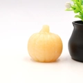 Carved natural yellow calcite pumpkin figurine for Halloween home decor and ornaments - Topaz