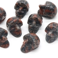 Polished natural Red Jasper crystal skull carving with dark spotted texture - Sesame Jasper