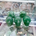 Set of five green aventurine crystal skull carvings with natural stone texture - Green Aventurine