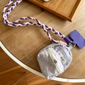 Grey quilted mini earphone bag with tricolor braided strap on a wooden desk - Red Hat Dog Grey