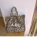Minimalist leopard print canvas tote bag with ABC letter embroidery on a white chair - Yellow Leopard Print Apc Large Size