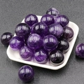 Polished 20mm natural amethyst crystal spheres displayed in a white tray for decor - Amethyst