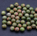 Polished 12mm unakite gemstone beads with natural green and orange mottled patterns - Unakite