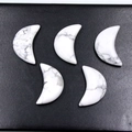 Five crescent moon-shaped white howlite stones with natural grey marble textures - Howlite