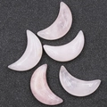 Set of five 30mm crescent moon rose quartz crystals on a black textured background - Rose Quartz