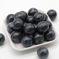Polished 20mm round labradorite stone beads with blue flash in a ceramic tray - Black Spectrolite