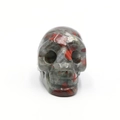 Hand-carved bloodstone crystal skull statue with grey-green tones and red spots - Bloodstone