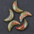 Five crescent moon-shaped unakite stones with polished green and reddish-brown mottling - Unakite
