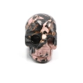Hand-carved pink rhodonite crystal skull figurine with natural black mineral veins - Rhodonite