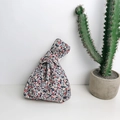 Floral Japanese knot bag with colorful ditsy patterns for phone and keys storage - Blue And Red Floral Knot Bag