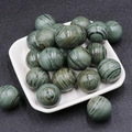 Polished 20mm round grey-green natural stones with black wood grain patterns in a tray - Panda Eye Stone
