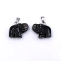 Polished black obsidian elephant pendants with silver metal bails on a white background - Obsidian