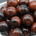 Polished mahogany obsidian stone spheres with natural reddish-brown and black textures - Golden Swan Stone