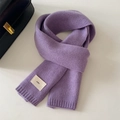 Detail of purple knitted winter scarf featuring textured weave and emo brand fabric label - 20x156cm / Purple