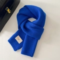 Detail of Klein blue knit scarf texture with a white minimalist woven emo label - 20x156cm / Dark Blue