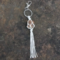 Handcrafted macrame keychain featuring raw dark brown gemstone with cotton tassel fringe - Tiger's Eye