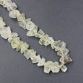 Irregular pale yellow raw crystal quartz beads strung on a line for DIY jewelry - Citrine