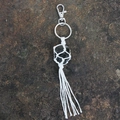 Handcrafted key chain featuring black raw gemstone wrapped in white cotton macrame netting - Smoky Quartz