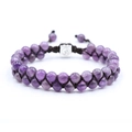 Braided bracelet with amethyst beads and silver Om charm on white background - Amethyst