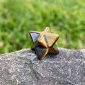 Natural tiger eye stone Merkabah star ornament with smooth polished finish on stone base - Tiger's Eye