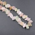 Natural raw fluorite beads in irregular purple and green shapes on pink cord - Colorful