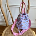 Lavender quilted bucket bag with cute bear patterns and pink straps on a wooden chair - Taro Purple (Bear Print)