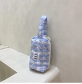 Detail of light blue quilted gingham handbag with daisy zipper and tulip patch - Blue Plaid Makeup Bag