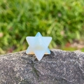 Opalite Merkaba star crystal ornament with 20mm geometric facets on grey stone - Opal (Synthetic)