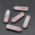 Natural rose quartz hexagonal prisms showing soft pink healing crystal stones - Rose Quartz