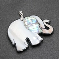 Elephant shell pendant with white and abalone shell inlays on a grey textured background - Style 1 Elephant