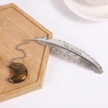 Silver feather metal bookmark with tiger eye stone moon pendant on a wooden tray - Tiger's Eye