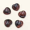 Set of mahogany obsidian heart stones with red and black mottled texture on fabric - Mahogany Obsidian