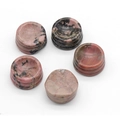 Five rhodonite crystal ball bases with natural pink and black veins on white background - Rhodonite
