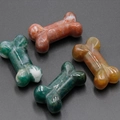 Set of four polished natural crystal agate bone-shaped pendants in earthy tones - India Agate