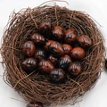 Polished mahogany obsidian egg-shaped gemstones nestled in a decorative bird nest - Gold Swan Stone (1pc)