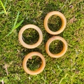 Natural orange agate ring set of four with smooth polished texture on green moss - Topaz
