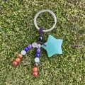 Handmade chakra energy stone keychain with green star crystal on moss background - Green Aventurine