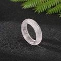 Minimalist pink quartz stone ring with smooth translucent finish on a dark textured base - Rose Quartz