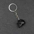Polished black obsidian skull keychain with silver metal ring for Halloween decor - Obsidian