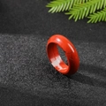 Polished red jasper ring with unique natural patterns on a black textured background - Red Jasper