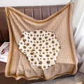 Close-up of vintage floral silk scarf with earth tones and geometric borders on leather - 90x90cm / Camel